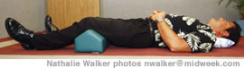 Chiropractor Chip Abbadessa demonstrates the proper posture for sleeping on your side and back
