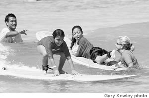 The kids from HUGS loving life through surfing at Waikiki