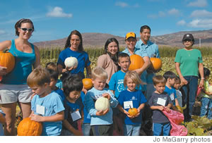 In the pumpkin patch with children and teachers from Hawaii Kai Church Early Learning Center are Aloun Farms' Terry Phillips (back row, third from right) and volunteers from Campbell High School