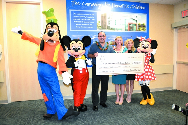 At the $250,000 check presentation were (from left) Goofy, Mickey Mouse, Aulani Resort vice president and general manager Elliot Mills, Kapiolani hospital CEO Martha Smith, Kapiolani Health Foundation director of philanthropy Linda Jameson and Minnie Mouse. Photo courtesy of Kapiolani Health Foundation.