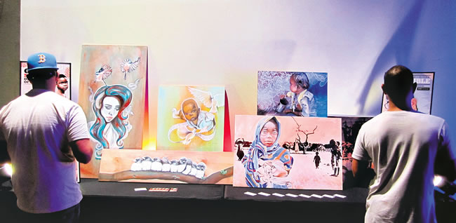 Attendees enjoy artwork at a REVO event