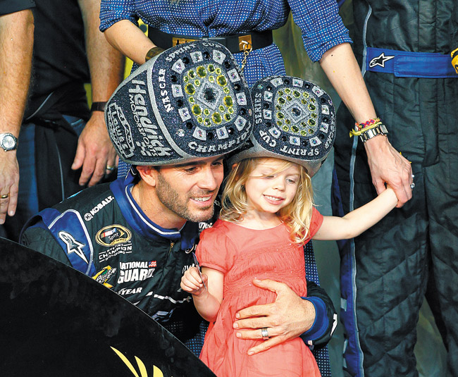 The hats may look silly, but Jimmie Johnson (with daughter Genevieve) is part of sport's greatest dynasty. AP photo