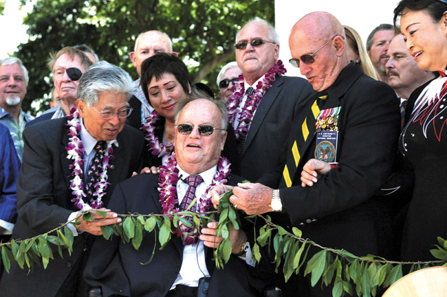 Flanked by veterans, former Sen. Daniel Akaka, Congresswoman Colleen Hanabusa, American Battle Monument Commission secretary Max Cleland and National Memorial Cemetery of the Pacific Superintendent Gene Castagnetti untie a maile lei, officially dedicating the new Vietnam War pavilion at the memorial following the annual Veterans Day ceremony on Nov. 11. The new Vietnam War pavilion combined with the already existing Vietnam War Courts of the Missing at Punchbowl constitute the only federal memorial to veterans of the Vietnam War built solely with federal funds. AP / American Battle Monuments Commission photograph
