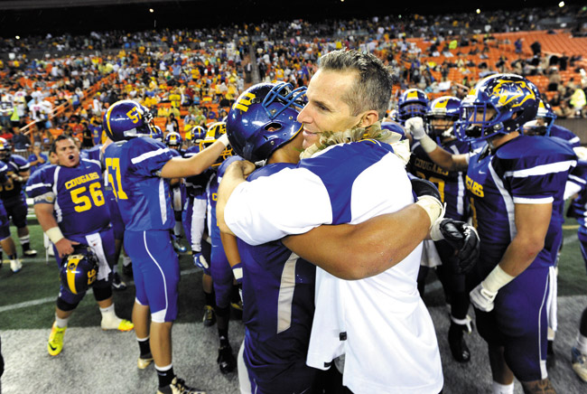 Kaiser High coach Rich Miano hugs Parker Higgins as the team celebrates at the end of the Cougars' OIA DII championship win over Pearl City at Aloha Stadium. The celebration was repeated a few weeks later when Kaiser defeated Kauai for the state title