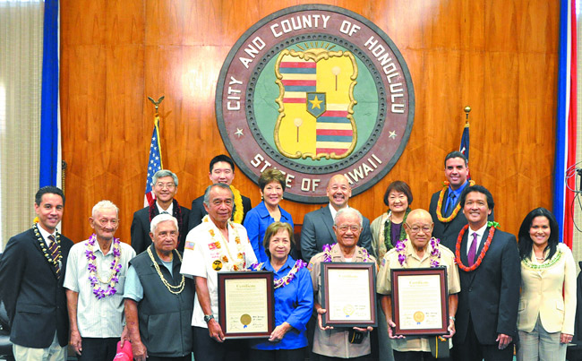 Honolulu City Council presented honorary certificates last month to a group of veterans. Pictured (front, from left) are Councilman Joey Manahan, veterans Angelicio Pegar, Francisco Obina, Ben Acohido, Anita Acohido, Lucio Sanico and Domingo Los Banos, Councilmembers Ron Menor and Kymberly Pine, (back, from left) Councilmembers Breene Harimoto, Stanley Chang, Carol Fukunaga, Ernie Martin, Ann Kobayashi and Ikaika Anderson. Photo from Ron Menor.