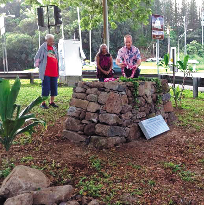 (from left) Alice Hewett, Mapuana de Silva and Terry George pay tribute with leis at the blessing of the restored stone ahu marker. Photo by Mahealani Cypher. 