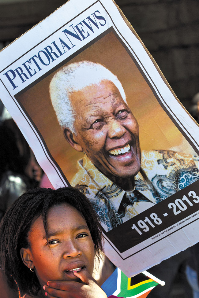 A girl waits in line to see the remains of Nelson Mandela at the Union Buildings in South Africa, where his body lies in state. AP Photo/Peter Dejong
