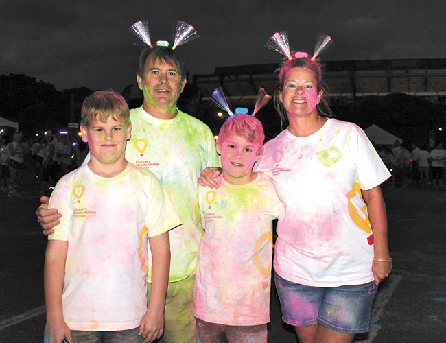 Blake (from left), Rory, Carsen and Donna Otto at the Neon Vibe 5K Jan. 3 at Aloha Stadium | Yu Shing Ting photo 