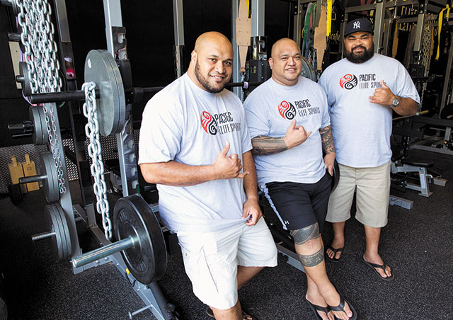 Ma'ake Kemoeatu (left) and brother Chris (right) at their new sports and fitness center in Kaneohe. The brothers are pictured here with close friend and fellow NFL veteran Vince Manuwai. The new training facility opened Jan. 24 in renovated warehouse space on Alaloa Street, just mauka of Windward Mall. Photo by Rachel Breit, rbreit@midweek.com.