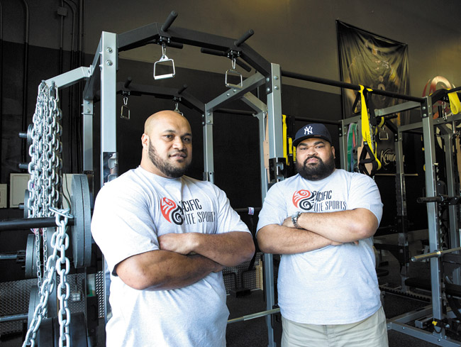 NFL veterans and Kahuku High School graduates Maake and Chris Kemoeatu celebrate the opening of their Pacific Elite Sports Fitness Center Jan. 22 in Kaneohe. The center specializes in sports performance training, fitness and tactical performance. Photo by Rachel Breit, rbreilt@midweek.com. 