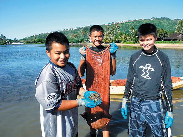 Students (from left) Jonah K., Jaydon T. and Maxwell S. show off their catch of mudweed and gorilla ogo removed Dec. 17 from Maunalua Bay by Kuliouou, where invasive species continue to choke out native marine plants. The boys from Our Lady of Good Counsel School were on a field trip from their Pearl City campus. All told, they collected nearly 140 bags of unwanted seaweed in four hours. Malama Maunalua's next ‘huki event' is this Friday, meeting at 9 a.m. at Kuliouou Beach Park. Call 395-5050 or see Highlights on Page 11. Photo from Ginger Kamisugi.