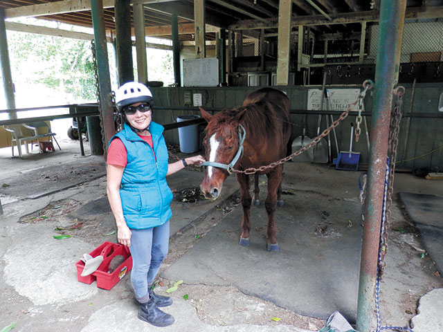 Owner Emogene Yoshimura, DVM, with one of her equine tenants at Koko Crater Stables. Photo by Kimo Franklin.
