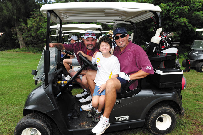 Team Baseball, World Series champions David Wells (left) and Kevin Millar (right), with 2013 Kapiolani Children’s Miracle Network champion Ikaika Ka‘ahanui (10), who served as their ‘Miracle Caddy’ in last week’s Ace Hardware Shootout golf tournament. Team Baseball won the tourney | Nathalie Walker photo 