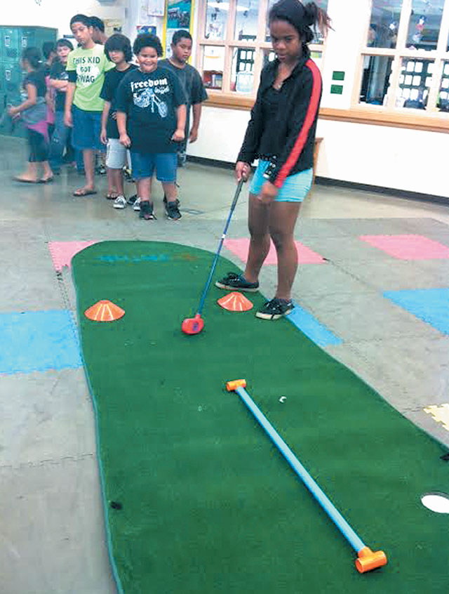 Aspiring young golfers at the Boys & Girls Club in Nanakuli enjoy their new indoor putting green, courtesy of Th!nk LLC. The company donated similar sets to Boys & Girls chapters in Ewa Beach and throughout Oahu and Kauai. Photo courtesy of Boys & Girls Club.