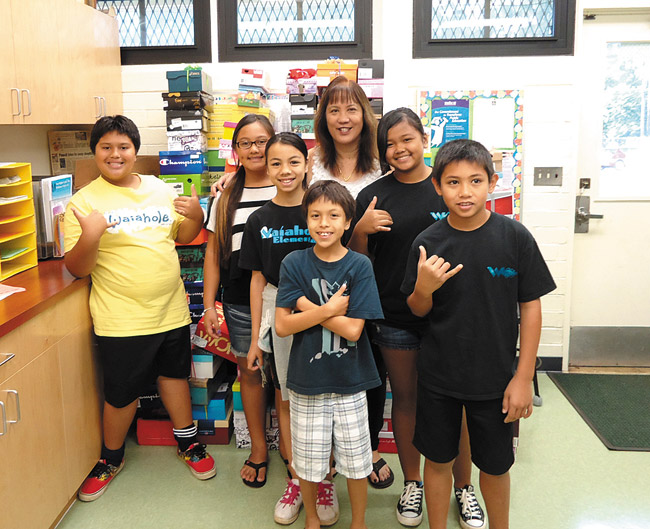 Waiahole Elementary School students demonstrate the can-do attitude that helped their school earn first place in the 2014 Shoeboxes for the Homeless competition. Together, Castle Complex schools filled 1,200 shoeboxes with food, toiletries and essentials for area homeless families. Pictured are (front, from left) Spencer Silva, Jayven Kane, (middle) JoAnna AhNee, Kaye Cacho, (back) Micah Eaton, Cayla Enos and school health aide Chris Sas-Lopes. Photo from John Au.