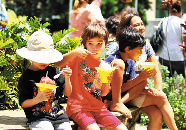 As in this image from the 2013 festival, families come in droves to Windward Community College's Paliku Arts Festival for the hands-on art activities. But they also pause to enjoy a little shave ice. This year's free campus art adventure is set for April 5. Photo from Bonnie Beatson. 