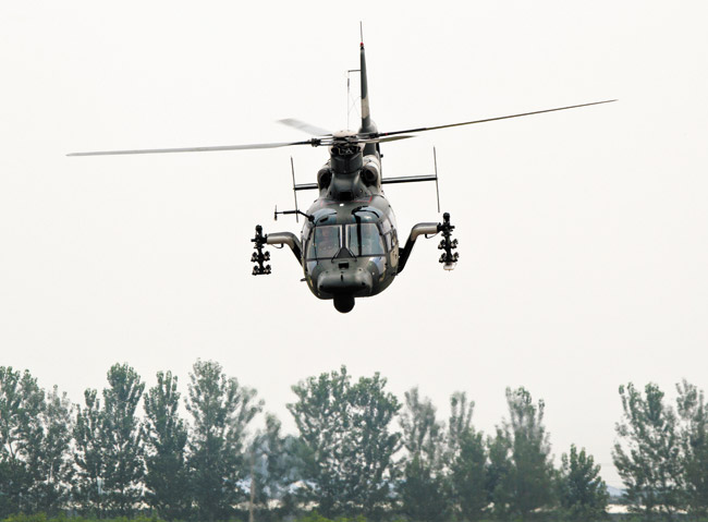 A Chinese Army Z-9WZ attack helicopter, designed and manufactured by China, performs a flight demonstration for press at a base of Chinese People's Liberation Army, Army Aviation 4th Helicopter Regiment | AP photo/Andy Wong 