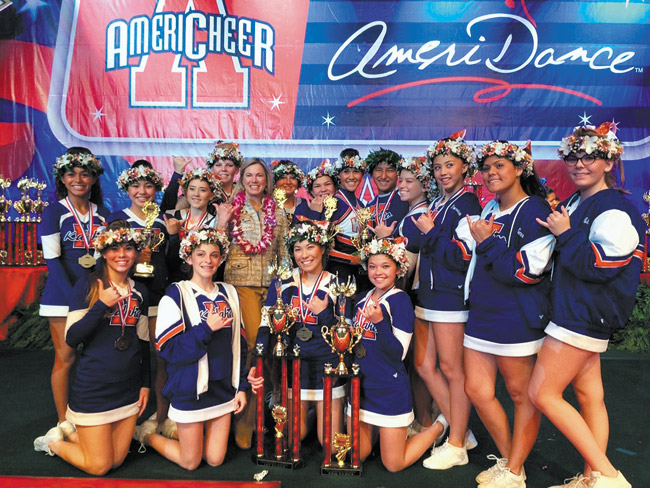 Kalaheo High School cheerleading coach Shannon Callen (center, with lei) and her national champion cheerleading team and trophies, following their triumphant performance at the Orlando, Fla., competition. Photo from Shannon Callen.