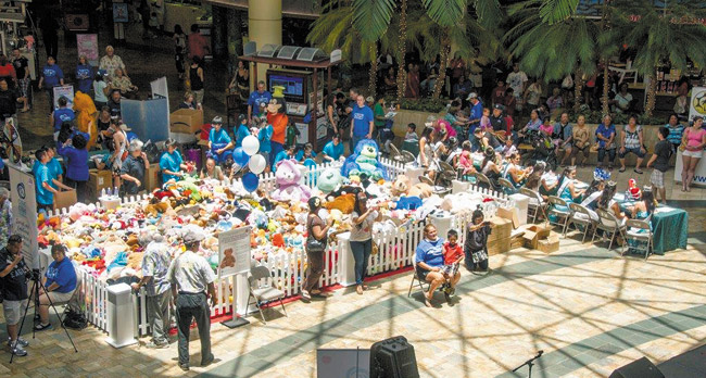 The 'barnyard' was full last year at Windward Mall's center court, where Prevent Child Abuse Hawaii attempted to break the Guinness World Record for 'largest gathering of plush toys.' They'll try again this year, from 10 a.m. to 2 p.m. Saturday. Called the Teddy Bear Round-Up, the event also aims to bring comfort to many of Hawaii's abused and neglected children. Photo from Aileen Deese. 