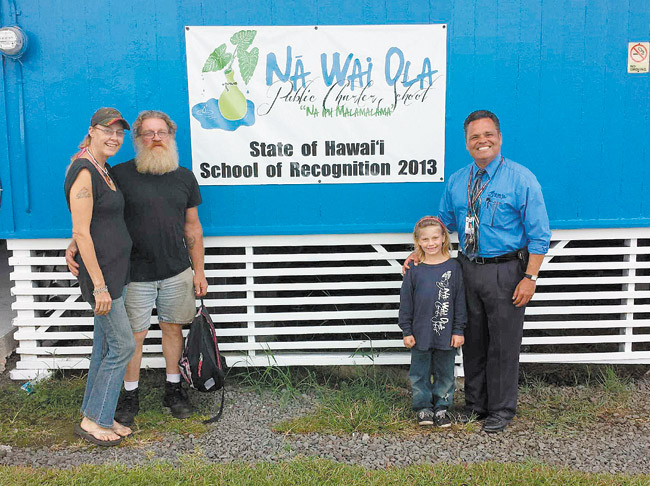 Anne Boog, Tim Hendricks, Harley Marie Hendricks and principal Daniel Caluya in front of Na Wai Ola Elementary | Photo courtesy Daniel Caluya 