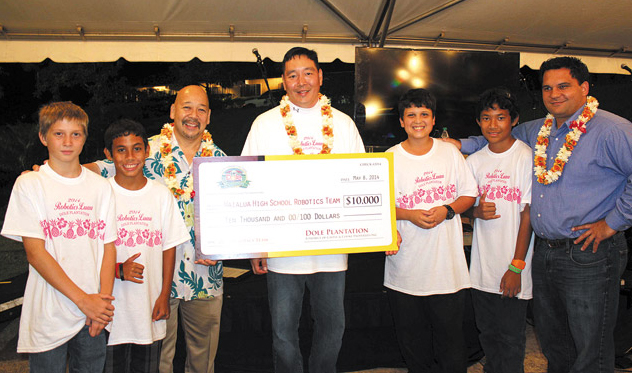 Waialua teacher Glenn Lee (center) and members of the Waialua Robotics team, along with City Council Chairman Ernie Martin (third from left) and state Rep. Richard Fale (far right), accept the $10,000 donation raised at Dole Plantation's annual fundraising luau. Photo from Dole Plantation.