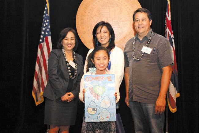 Mililani Mauka student Noelle Shimabukuro displays her poster with (from left) BWS deputy managing director Georgette Deemer, her teacher Gayle Horie and BWS chairman Duane Miyashiro. Photo from BWS. 