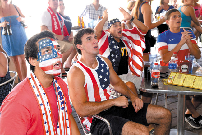 Jose Rodriguez, from left, Mark Dickinson, Luke Cantin, and Christian react to play early in the World Cup soccer match between the United States and Belgium last Tuesday in Jacksonville Beach, Fla. (AP PHOTO/THE FLORIDA TIMES-UNION, BOB MACK)