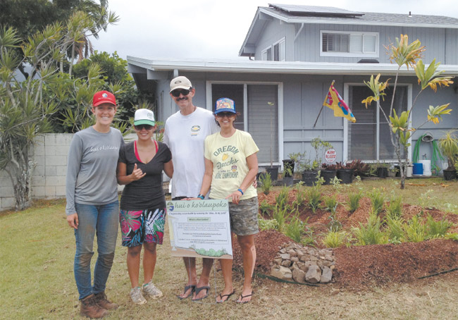 The Gomes family home in Enchanted Lake now has its own rain garden, with these proud installers standing by its side: (from left) Hui o Ko'olaupoko project coordinator Annie Lovell, and homeowners Maria, Paul and Lorna Gomes. Photo from Annie Lovell. 