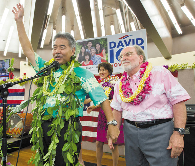 State Sen. David Ige (left) waves to his supporters and thanks Gov. Neil Abercrombie Aug. 9 after Ige defeated the governor in the primary election. AP PHOTO/EUGENE TANNER