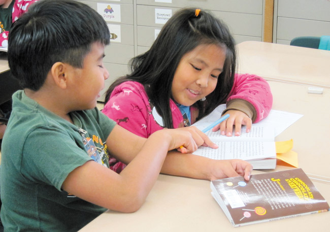 Helemano students Michael Yoro and Caithleen Pambid discuss the joy of reading in class. Photo from Helemano Elementary School. 