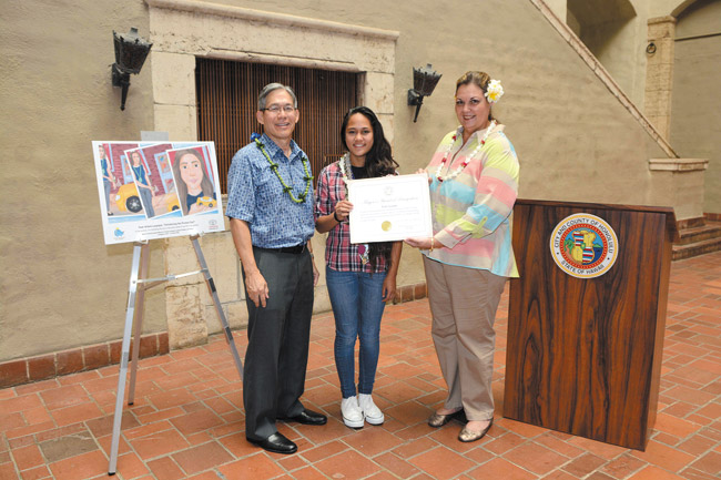 Teah Laupapa receives her mayoral certificate for her winning design in 2014 Toyota Dream Car Art Contest. Present were Toyota Hawaii/Servco's COO Rick Ching and Misty Kela'i, executive director of Mayor Caldwell's Office of Arts and Culture. Photo from Karyl Garland.