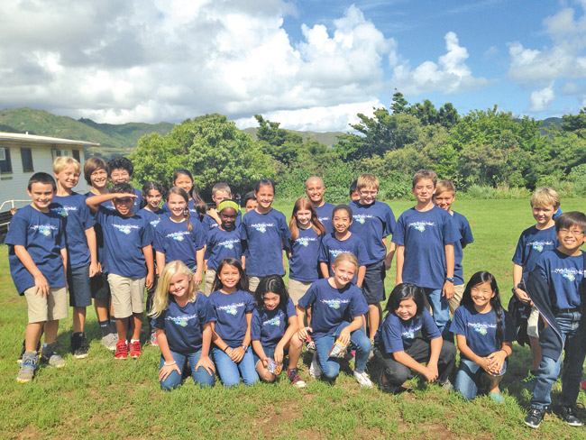 Students in grades 4-6 model their 2014 Makahiki T-shirts (designed by parent Scot Willson), as they prepare for the school's second annual Makahiki Oct. 25. Photo by Nancy Keegan. 