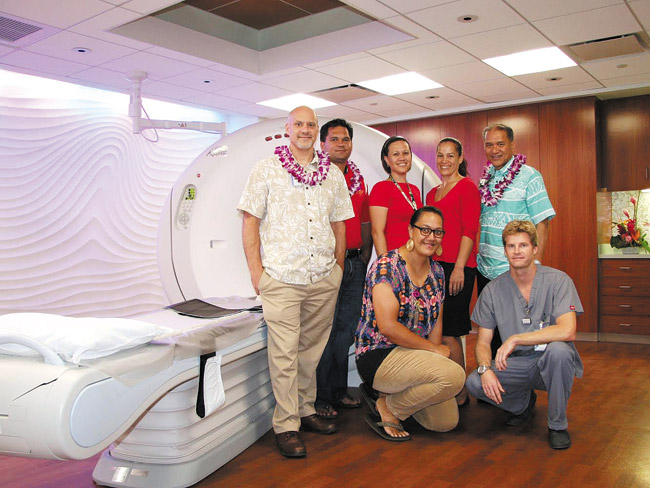 Kahuku Medical Center's open house last month offered the public a look at its new state-of-the-art CT scanner. Checking it out are (from left) KMC radiology manager Jay White, state Rep. Richard Fale, CEO Stephany Vaioleti, in-patient services manager Shannon Kamakeeaina, board member Bobby Akoi, (kneeling) pharmacy technician Musie Lauhingoa and radiology technician Todd Wass. Photo from Stephanie Chang Design Ink. 