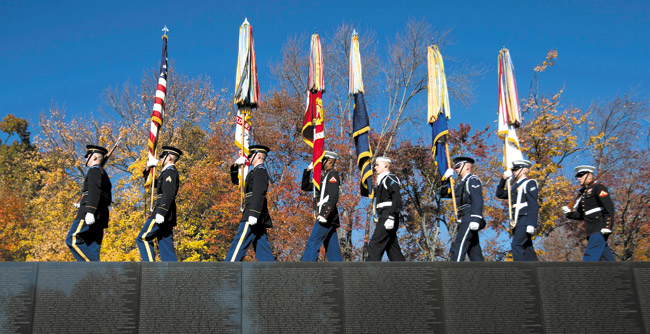 Military honor guards from different branches of the U.S. Armed Forces march along the Vietnam Veterans Wall Memorial in Washington, D.C., Nov. 11 during the commemoration of Veterans Day. Americans marked Veterans Day with parades, speeches and military discounts, while in Europe the holiday known as Armistice Day held special meaning in the centennial year of the start of World War I AP PHOTO BY MANUEL BALCE CENETA 