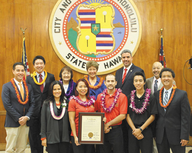 The Roberts family, founders of Hybrid Kempo Martial Arts School, were honored by the Honolulu City Council Nov. 12. Pictured are (back, from left) City Councilmen Joey Manahan and Stanley Chang, Councilwomen Ann Kobayashi and Carol Fukunaga, Councilmen Ikaika Anderson and Ernie Martin, (front) Councilwoman Kymberly Pine, Jocelyn Tecson-Roberts, James Anthony Roberts, son Noah Roberts and Councilman Ron Menor. Photo from Kymberly Pine's office. 