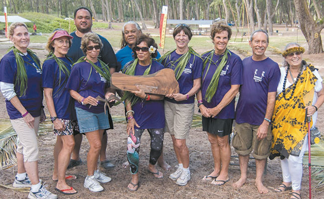 The kupuna paddlers of Keahi Aka Hoe accepted the inaugural Kahu Ryan K. Kalama Malama Award Nov. 22 at the 2014 Waimanalo Makahiki. Given in memory of Kalama, a makahiki co-founder who died just prior to last year's event, the perpetual award honors his legacy of excellence. At the presentation were (from left) Susan Heitzman, Mary Martin, Judy Thurston, Hawaiian Civic Club Waimanalo cultural liaison Kalani Kalima, HCCW president Maynard B. Koa, Aunty Nani Akeo (holding trophy), Sara Watson, Mimi Frank, Makahiki committee member Eric Kane and Pastor Suzi Mann (HCCW member). Photo from Roy Brooks.