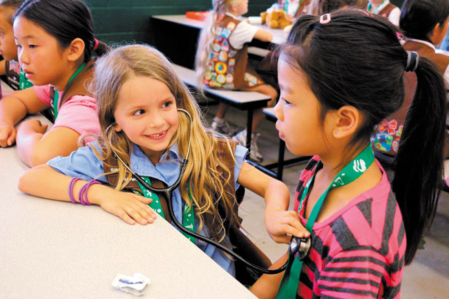 Ashlee Sakamoto (from left) of Girl Scout Troop 84, Hayden Rice of Troop 445 and Jennifer Leong of Troop 293 participate in last month's STEM Fest 2014 at Webling Elementary School in Aiea. Photo from Valerie Moore. 