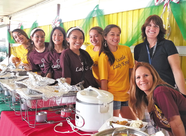 Lady Knights soccer players serve up delicious samplings from the high school's popular fundraising cookbooks at the 2013 ‘Taste of Castle.' They are (from left) Jenai Polendey, Chanel Uehara, Deandra Muraoka, Destinee Hanaike, Shea Kauanui, Kaile Kauanui and team parents Laura Chinen and Trina Takasato. This year's ‘Taste' and craft fair — a benefit for Project Grad — will be open from 9:30 a.m. to 2:30 p.m. Dec. 7. Photo by Teri Lynn Sato.