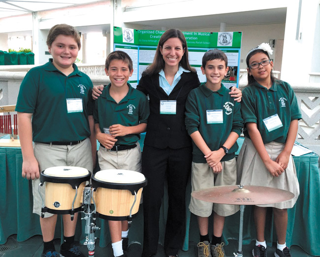 Taking a break from rehearsal for St. John Vianney School music department's winter concert are teacher Dana Arbaugh (center) and her four percussionists (from left) Michael Brede, Kaulana Kau, Joseph Iverson and Liberty Lum. The show goes on Dec. 10. Photo from St. John Vianney School.