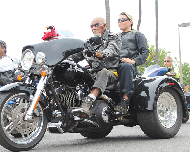 Tiger Wong riding with granddaughter Iana in 2013. Photo from Zombie Frog Productions.