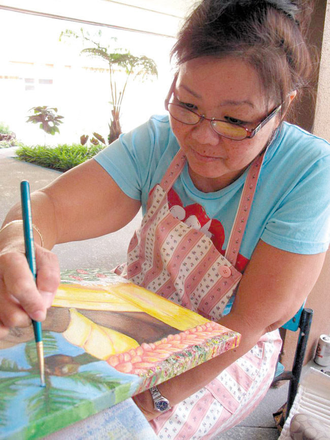 Susan Fonseca paints during the Creative Arts Program at REHAB. Photo courtesy of the hospital.  