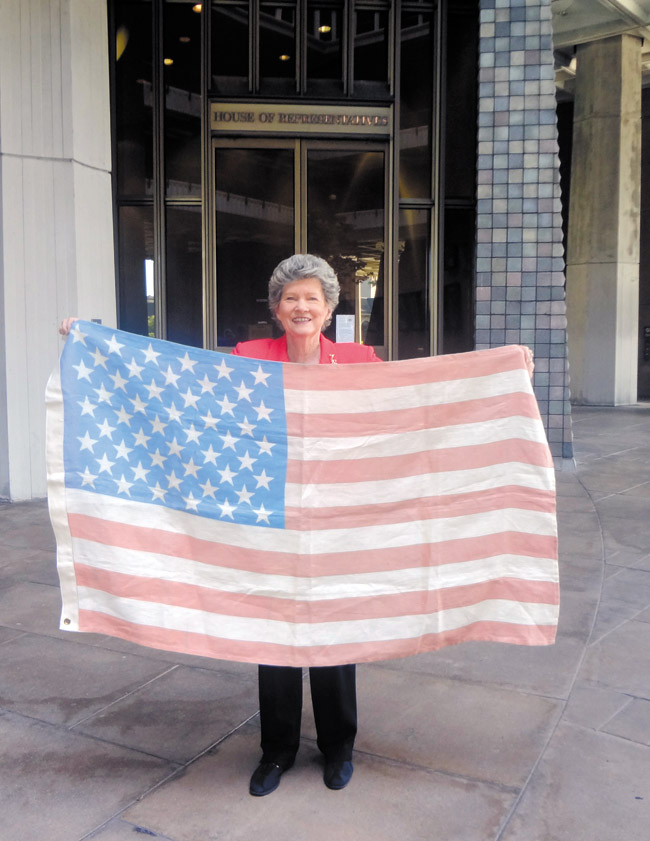Rep. Thielen shows off the American-grown andand -raised hemp flag, which was flown at the U.S. Capitol and four other states. Photo from Rep. Thielen. 