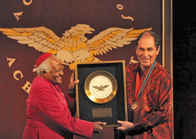 Justice Albie Sachs (far right) of South Africa's Constitutional Court receives the Academy of Achievement's Golden Plate, an award of exceptional accomplishment, from Archbishop Desmond Tutu at the Academy's 2009 International Achievement Summit in Cape Town Photo courtesy of Doris Duke Theatre