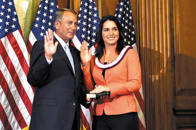House Speaker John Boehner of Ohio poses for a photo with Rep. Tulsi Gabbard, D-Hawaii to re-enact the House oath-of-office, Tuesday, Jan. 6, 2015, on Capitol Hill in Washington SUSAN WALSH / AP PHOTO 