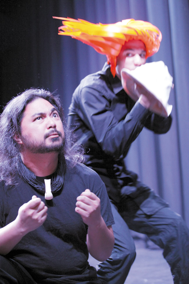 Kiha (Jonathan Saavedra) is tormented by the sound that the akua (Brandon DiPaola) coaxes from his magical pu, in a scene from Moses Goods' ‘The Magical Pu Stealer.' Windward Community College's Hawaiian Youth Theatre brings the Hawaiian mo‘olelo to the Paliku Theatre stage Feb. 12-14 and 19-21. Photo by Bonnie Beatson.