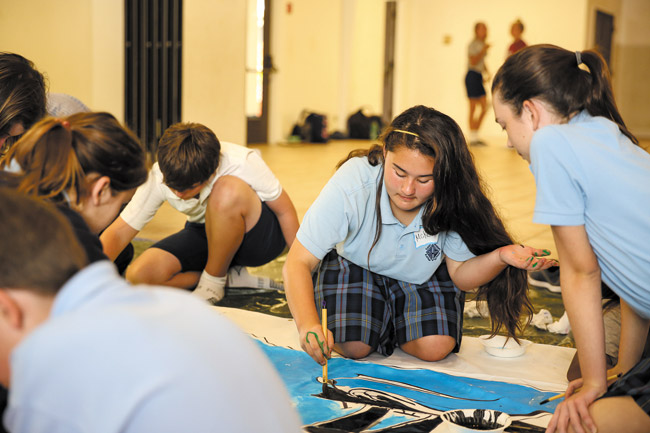 St. Anthony School students, including McKenzie Miyata and Kyra Fo, work on a special peace mural Feb. 19 with peers from Japan in Father Henry Hall at the Kailua church. Photo by Bodie Collins, bcollins@midweek.com. 