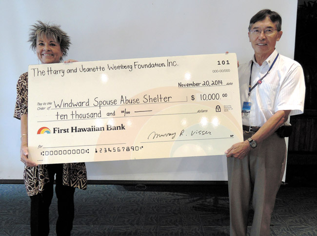 Murray Visser (right), president of Rotary Club of Windward Oahu, presented this $10,000 check to Wind-ward Spouse Abuse Shelter executive director Avis Kalama. The club earned the Weinberg Friends grant through community service in order to give it to a charity of its choice. Photo from Murray Visser. 