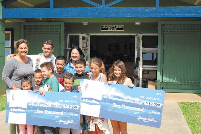 Sunset Beach Elementary School (back, from left) principal Bernadette Tyrell, surfer Mason Ho and Sunset Beach vice principal Teresann Taua with students holding $10,000 in checks. Photo from DOE. 