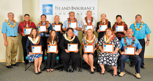 Haleiwa Elementary School principal Malaea Wetzel (front, second from right) and the 12 other Masayuki Tokioka Excellence in School Leadership Award nominees show off their awards March 28 at the Island Insurance offices. The educators are joined by Island Insurance Foundation president Tyler Tokioka (standing, left) and DOE deputy superintendent Ronn Nozoe (standing, right). Photo by Schechter Photography. 