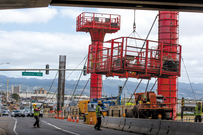 WDA Workers place a platform on top of a railway column near the intersection of Kunia Road and Farrington Highway  CRAIG T. KOJIMA / STAR-ADVERTISER PHOTO 